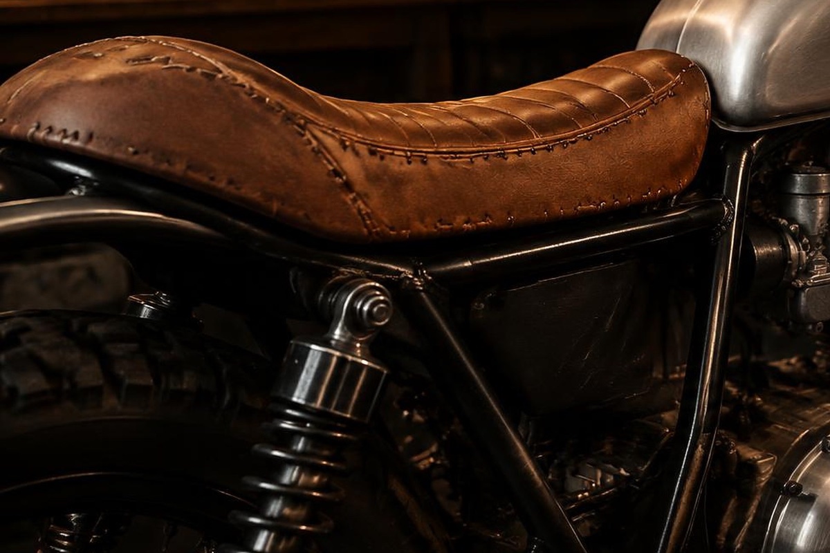 Hand-stitched brown leather seat on a custom café racer